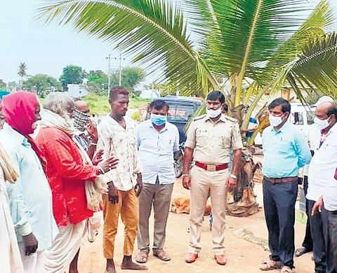 Social Welfare Department officials interact with residents of Nagankal village in Koppal district. (Photo | EPS)