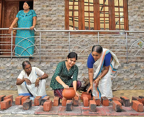 A family residing near Attukal Devi temple in Thiruvananthapuram making arrangements in front of their home on the eve of Pongala | B P Deepu