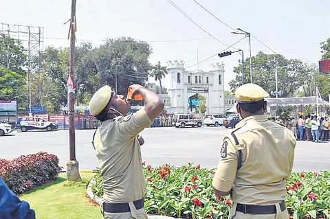 Policemen on duty near the Assembly quench their thirst as the mercury keeps soaring in Hyderabad | R V K Rao