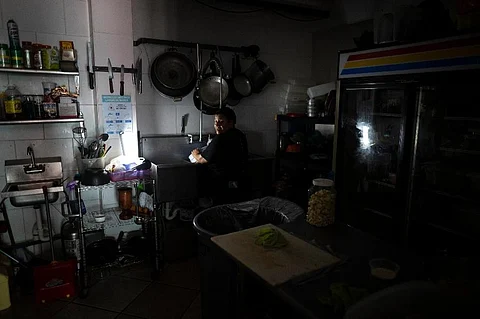 Workers at Las Palmas Cafe work with the power of an electricity generator during an island-wide blackout, in San Juan, Puerto Rico,. ( Photo | AP)