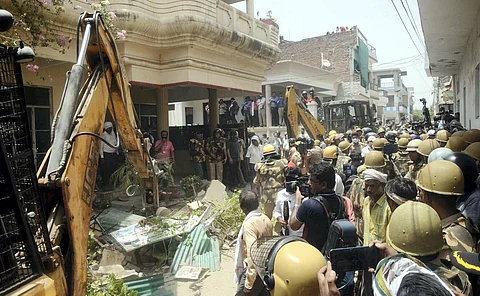 A bulldozer being used to demolish the residence of Javed Mohammad in Prayagraj. (Photo | PTI)