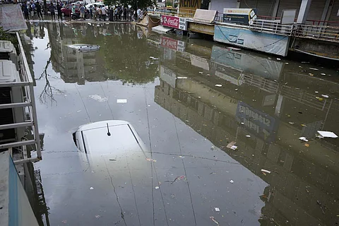 Vehicles seen submerged at a water logged shopping complex after heavy rain lashed different parts of the city.