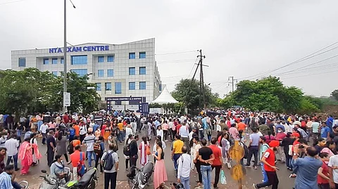 Students gather outside an exam centre after the Common University Entrance Test