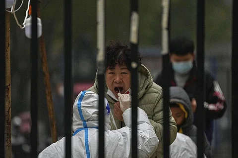 A woman has her routine COVID-19 test at a coronavirus testing site setup inside a residential compound in Beijing. (File photo | AP)