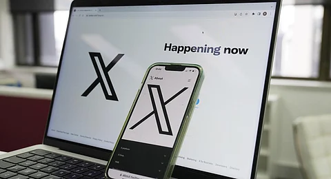 The opening page of X is displayed on a computer and phone. (Photo | AP)