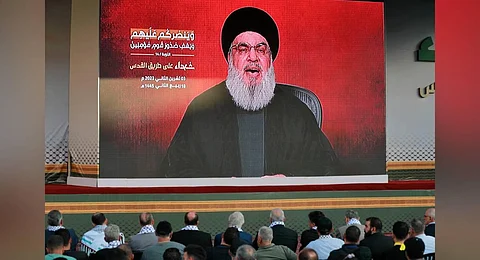 Supporters of the Lebanese Shiite movement Hezbollah watch a televised speech by its leader Hassan Nasrallah in Beirut | AFP