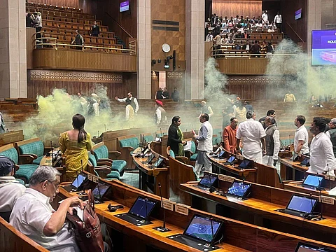 Two protesters jumped into the Lok Sabha chamber from the public gallery, released yellow gas from canisters and shouted slogans, Dec 13, 2023. (Screengrab | SansadTV)