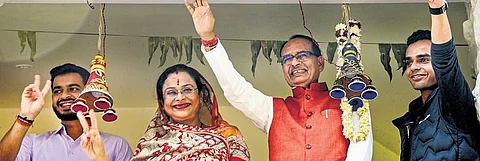 Madhya Pradesh Chief Minister Shivraj Singh Chouhan with family members celebrates BJP’s lead during the counting of votes in Bhopal on Sunday| pti
