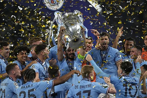 Manchester City's Ilkay Gundogan holds up the trophy after winning the Champions League final soccer match between Manchester City and Inter Milan. (Photo | AP)