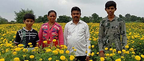 Mr. kate with his family in marigold flower plot