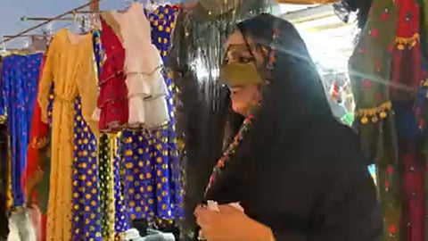 إحدى المواطنات العاملات في بيع الأزياء