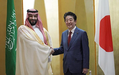 Saudi Arabia's Crown Prince Mohammed bin Salman, left, and Japanese Prime Minister Shinzo Abe, right, shake hands during their meeting in Osaka, western Japan Sunday, June 30, 2019. Eugene Hoshiko/Pool via REUTERS