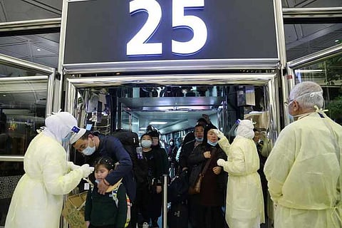 Passengers coming from China wearing masks to prevent a new coronavirus are checked by Saudi Health Ministry employees upon their arrival at King Khalid International Airport, in Riyadh, Saudi Arabia January 29, 2020.