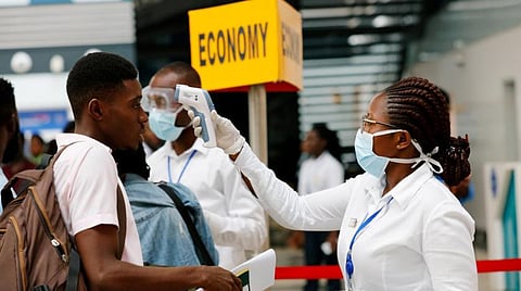 A health worker checks the temperature of a traveller as part of the coronavirus screening procedure at the Kotoka International Airport in Accra, Ghana January 30, 2020. (Reuters)