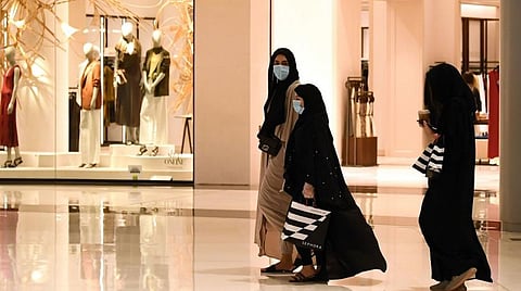 Women wearing masks for protection against the coronavirus, walk in the Mall of Dubai on April 28, 2020. (Getty Images)