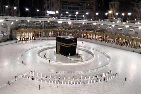 A small group of worshippers pray at Kaaba in the Grand Mosque while practicing social distancing, following the outbreak of the coronavirus disease (COVID-19)