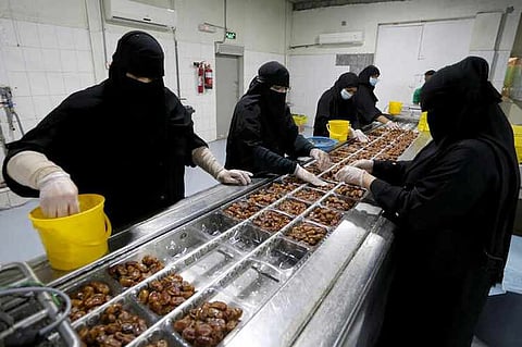 Saudi women work at a dates packaging factory in Al-Ahsa, Saudi Arabia, September 10, 2020.