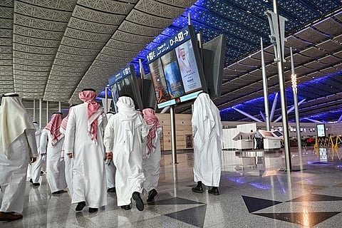 Men walk inside a terminal building at Saudi Arabia's King Abdulaziz International Airport in Jeddah on December 12, 2019. (Photo by GIUSEPPE CACACE / AFP)
