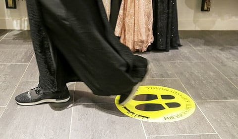 A Saudi woman walks on a social distancing marker at a shopping center, as preventive measures against the spread of the coronavirus disease (COVID-19), in Riyadh, Saudi Arabia May 3, 2020. (REUTERS)