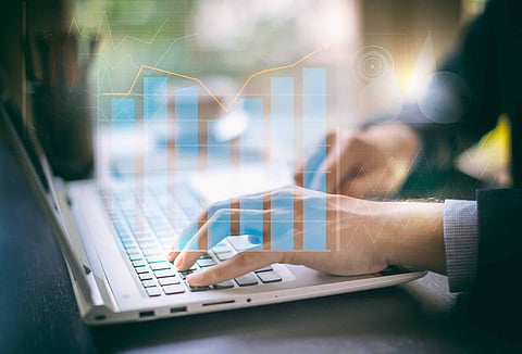 business documents on office digital computer laptop and graph financial with social network diagram and man working in the background