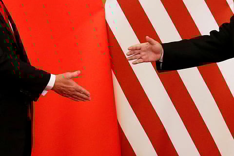U.S. President Donald Trump and China's President Xi Jinping shake hands after making joint statements at the Great Hall of the People in Beijing, China, November 9, 2017. Damir Sagolj: "It's one of those "how to make a better or at least different shot when two presidents shake hands several times a day, several days in row". If I'm not mistaken in calculation, presidents Xi Jinping of China and Donald Trump of the U.S. shook their hands at least six times in events I covered during Trump's recent visit to China. I would imagine there were some more handshakes I haven't seen but other photographers did. And they all look similar - two big men, smiling and heartily greeting each other until everyone gets their shot. But then there is always something that can make it special - in this case the background made of U.S. and Chinese flags. They shook hands twice in front of it, and the first time it didn't work for me. The second time I positioned myself lower and centrally, and used the longest lens I have to capture only hands reaching for a handshake." REUTERS/Damir Sagolj/File Photo  SEARCH "POY TRUMP" FOR THIS STORY. SEARCH "REUTERS POY" FOR ALL BEST OF 2017 PACKAGES.    TPX IMAGES OF THE DAY