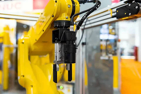 Robot arm in a factory working for the humans