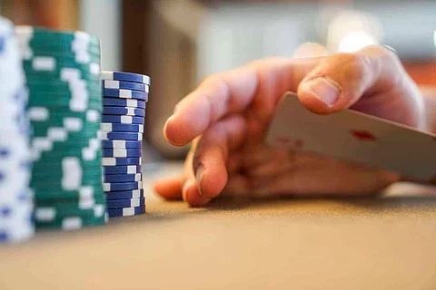 holding a card secretly exposed view at a poker table