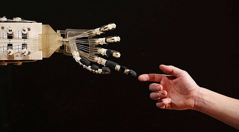 LONDON, ENGLAND - NOVEMBER 29: Robotics student Gildo Andreoni interacts with a Dexmart robotic hand built at the University of Bologna in the Robotville exhibition at the Science Museum on November 29, 2011 in London, England. The Science Museum's Robotville exhibition showcases 20 unique and cutting-edge robots from European research laboratories, it is free to enter and runs from December 1-4, 2011. (Photo by Oli Scarff/Getty Images)