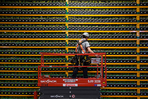 A technician inspects the backside of bitcoin mining at Bitfarms in Saint Hyacinthe, Quebec on March 19, 2018.
Bitcoin is a cryptocurrency and worldwide payment system. It is the first decentralized digital currency, as the system works based on the blockchain technology without a central bank or single administrator. / AFP PHOTO / Lars HagbergLARS HAGBERG/AFP/Getty Images