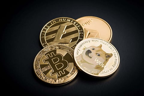 Dogecoin, litecoin, ethereum and bitcoin on black backgrund.