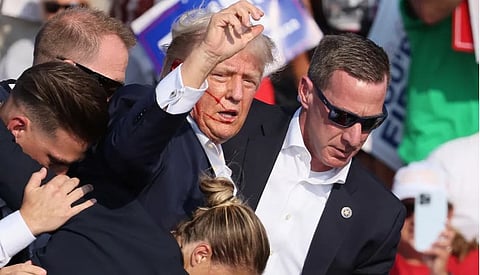 டிரம்பை பாதுகாப்பாக அழைத்துச் செல்லும் பாதுகாப்புப் படையினர்