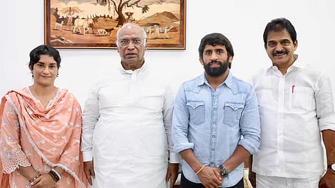 Wrestlers Vinesh Phogat and Bajrang Punia with Congress president Mallikarjun Kharge and party leader KC Venugopal.