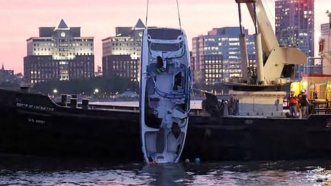 The tour boat Stimulus Money is pulled out of the water after its July 12, 2022 capsizing.