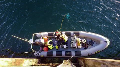 Tritonia Scientific personnel prepare to deploy an ROV into the water. (representative photo only)