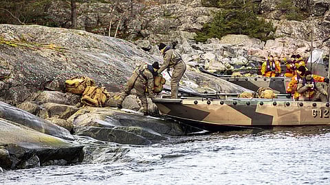 Marines assigned to the 2nd Reconnaissance Battalion, 2nd Marine Division, unload gear from a Finnish G-Class landing craft during trial insertion and extraction drills as part of Freezing Winds 23 off the coast of Dragsvik, Finland