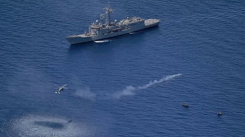 A warship and a helicopter deployed in support of Operation ATALANTA respond to a pirate attack on the Marshall Islands-flagged product tanker Chrystal Arctic off the coast of Somalia, May 2024.