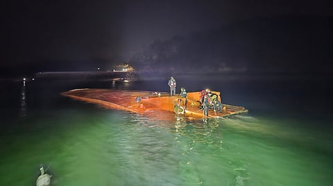 Divers inspect the upturned hull of a vehicle ferry that capsized off the South Korean city of Seosan on December 30, 2024. Only three occupants have been safely rescued while the captain was found in a state of cardiac arrest and later expired.