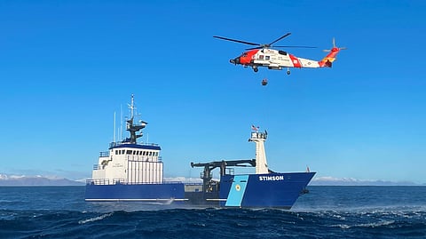The Alaska State Troopers' vessel Stimson and a US Coast Guard MH-60 Jayhawk helicopter during the operation to rescue the two crewmembers of the capsized fishing vessel Tanusha off Kodiak, January 15, 2025