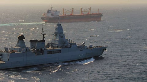 The German Navy frigate Hessen escorts a cargo ship through the Red Sea.