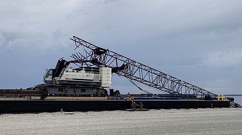 The boom bent backwards over the cabin after striking the bridge