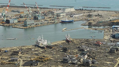 Aircrew from a C-130 surveys wreckage at a port in Matsushima, Japanfollowing an earthquake and tsunami in 2011