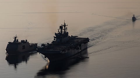 Amphibious assault ship USS Makin Island, right, transits with Philippine navy ships BRP Tarlac, left, and BRP Jose Rizal during a replenishment-at-sea rehearsal for Balikatan 23, April 15, 2023 in the Philippines territorial waters