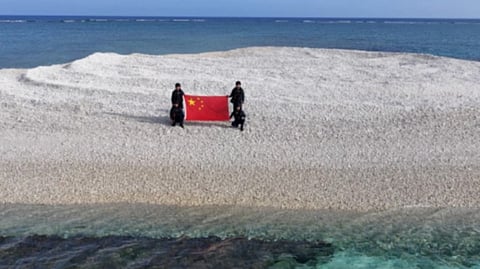 CCTV screenshot of Chinese Coast Guard personnel on Sandy Cay