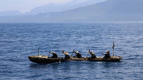 Researchers in a canoe during their experimental voyage along the East China Sea