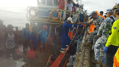 The rescued crew of the cargo ship San Juan Bautista being brought ashore