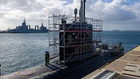 US Navy and Royal Australian Navy sailors attached to the submarine tender USS Emory S. Land perform maintenance aboard the Virginia-class attack submarine USS Hawaii at HMAS Stirling, Western Australia, in August 2024.
