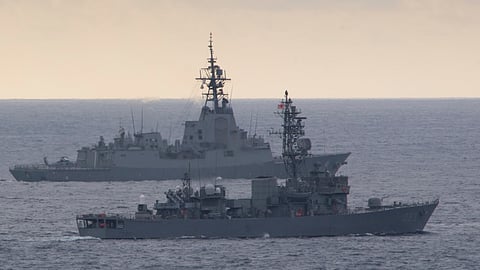 The Japan Maritime Self-Defence Force Abukuma-class destroyer escort JS Chikuma (foreground) and the Royal Australian Navy Hobart-class destroyer HMAS Brisbane sail in formation during an exercise in the Pacific Ocean, November 10, 2023.