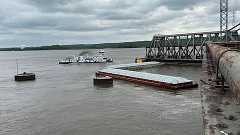 Two of the barges immediately after impact blocking the primary
channel. The barge next to the central wooden fendering is sinking while Joe B. Wyatt is
visible in the background.