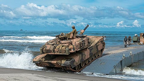 An Australian Army M1A1 Abrams tank from the 2nd Cavalry Regiment hits the shore during a combined amphibious assault activity on Exercise Alon 2023 in the Philippines