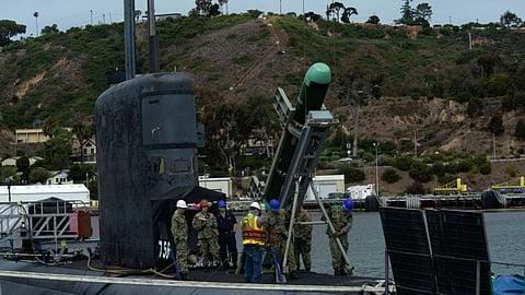 Sailors load a Mark 48 torpedo aboard the US Navy Los Angeles-class fast attack submarine USS Scranton.